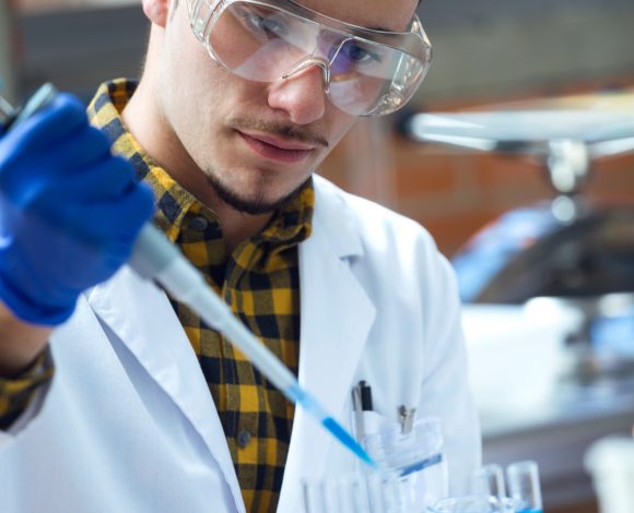 Concentrated scientist making experiment in laboratory. Biology