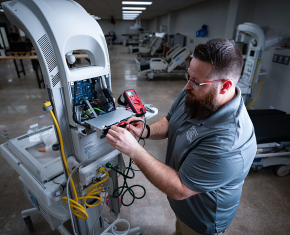 a student working on medical equipment
