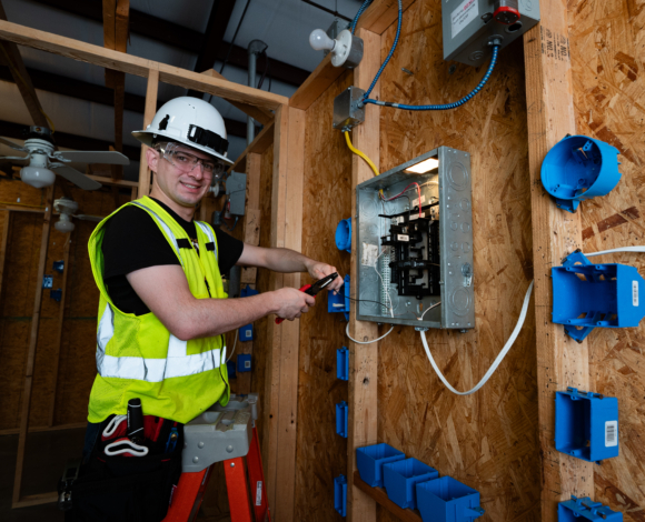 an electrical construction student practicing in the lab